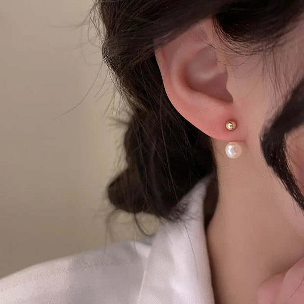 Gold hoop earrings with delicate pearls, ideal for jewelry storage, jewelry cleaning, and showcasing on jewelry websites by top jewelry designers for timeless style.