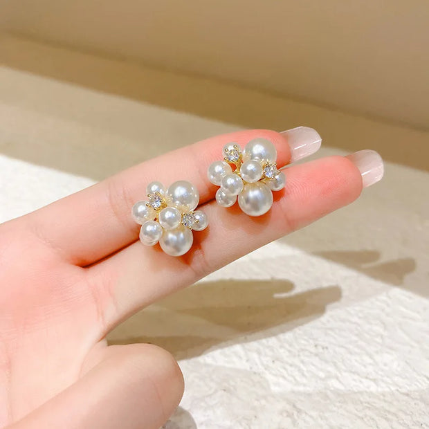 Gold hoop earrings with delicate pearls, ideal for jewelry storage, jewelry cleaning, and showcasing on jewelry websites by top jewelry designers for timeless style.