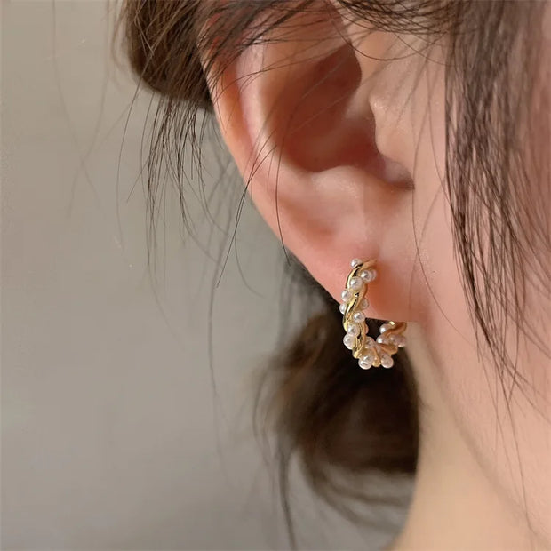 Gold hoop earrings with delicate pearls, ideal for jewelry storage, jewelry cleaning, and showcasing on jewelry websites by top jewelry designers for timeless style.