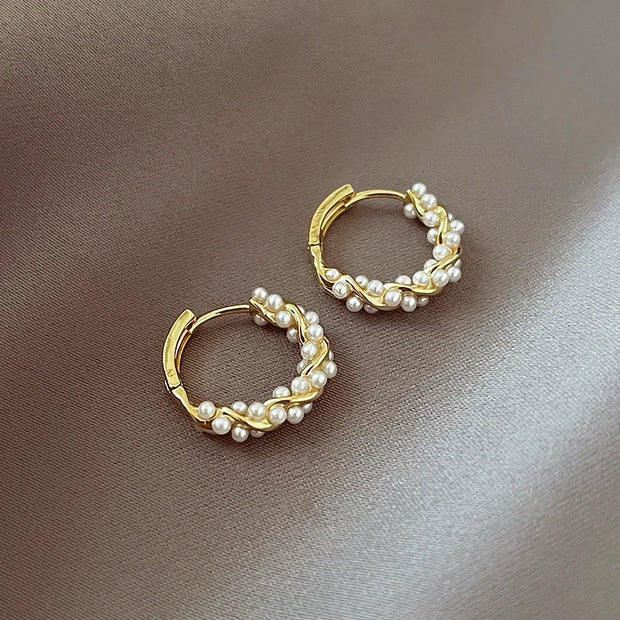Gold hoop earrings with delicate pearls, ideal for jewelry storage, jewelry cleaning, and showcasing on jewelry websites by top jewelry designers for timeless style.