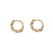 Gold hoop earrings with delicate pearls, ideal for jewelry storage, jewelry cleaning, and showcasing on jewelry websites by top jewelry designers for timeless style.