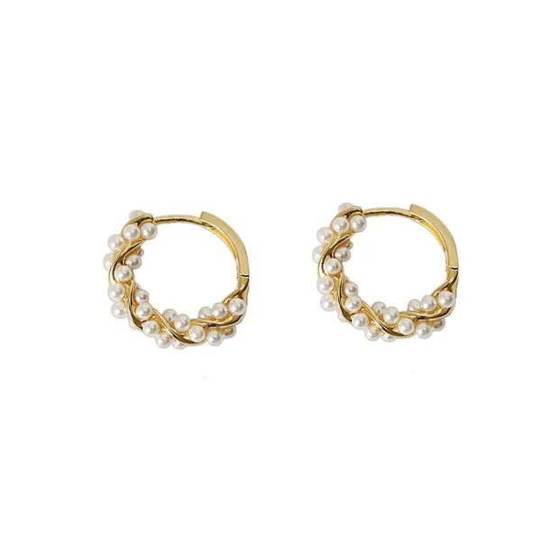 Gold hoop earrings with delicate pearls, ideal for jewelry storage, jewelry cleaning, and showcasing on jewelry websites by top jewelry designers for timeless style.