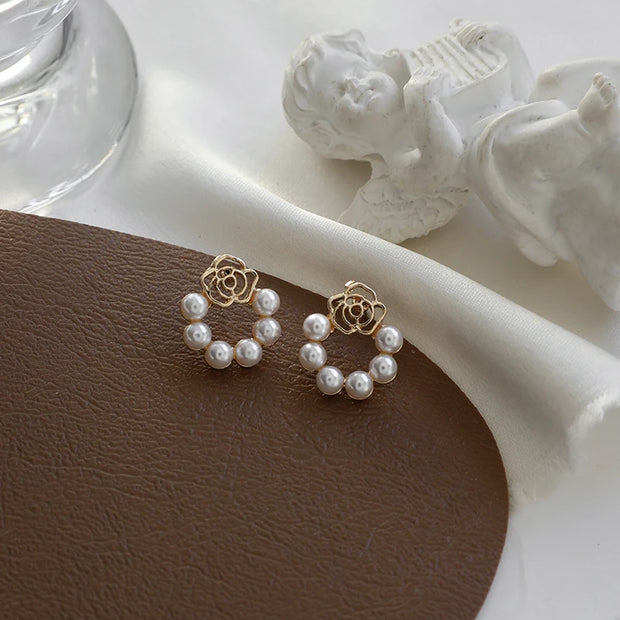 Gold hoop earrings with delicate pearls, ideal for jewelry storage, jewelry cleaning, and showcasing on jewelry websites by top jewelry designers for timeless style.