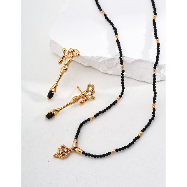 Gold pendant black beaded necklace, perfect for jewelry storage, jewelry websites, vintage jewelry collections, and as a timeless accessory for all occasions.