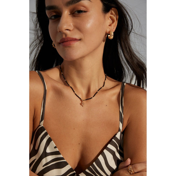 Gold pendant black beaded necklace, perfect for jewelry storage, jewelry websites, vintage jewelry collections, and as a timeless accessory for all occasions.