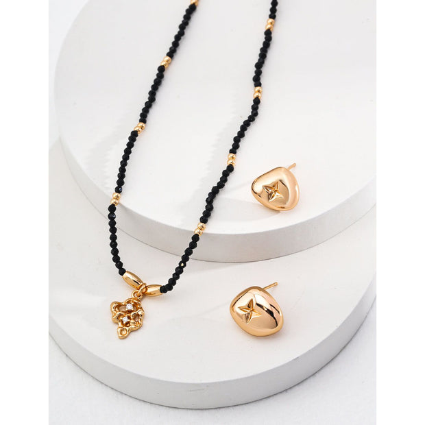 Gold pendant black beaded necklace, perfect for jewelry storage, jewelry websites, vintage jewelry collections, and as a timeless accessory for all occasions.