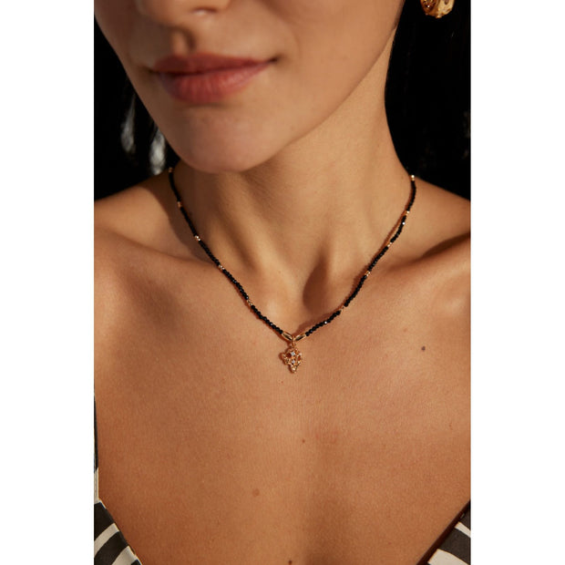 Gold pendant black beaded necklace, perfect for jewelry storage, jewelry websites, vintage jewelry collections, and as a timeless accessory for all occasions.