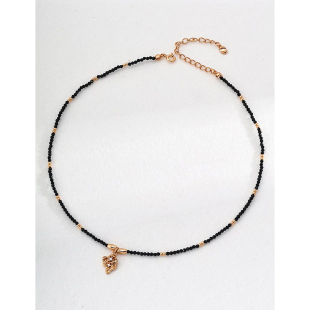 Gold pendant black beaded necklace, perfect for jewelry storage, jewelry websites, vintage jewelry collections, and as a timeless accessory for all occasions.