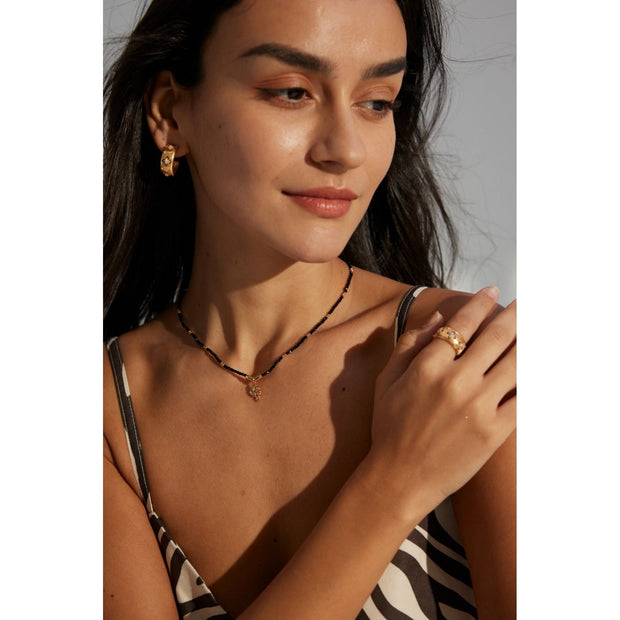 Gold pendant black beaded necklace, perfect for jewelry storage, jewelry websites, vintage jewelry collections, and as a timeless accessory for all occasions.