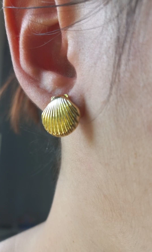 Elegant gold shell earrings for modern jewelry storage and display, designed by top jewelry designers. Ideal for jewelry websites featuring body jewelry, earrings rings, or vintage-inspired collections. Perfect for jewelry case organization, showcasing diamond and jewelry craftsmanship, and suitable for mature women hairstyles. A standout piece for jewelry cleaning and care enthusiasts.