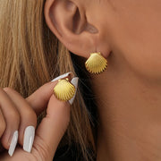 Elegant gold shell earrings for modern jewelry storage and display, designed by top jewelry designers. Ideal for jewelry websites featuring body jewelry, earrings rings, or vintage-inspired collections. Perfect for jewelry case organization, showcasing diamond and jewelry craftsmanship, and suitable for mature women hairstyles. A standout piece for jewelry cleaning and care enthusiasts.