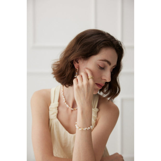 Gold and silver cuff rings with intricate detailing on a white surface, perfect for vintage jewelry collectors, jewelry designers, and jewelry websites. Ideal for jewelry storage, jewelry cases, and pairing with earrings rings or gem jewelry styles. A must-have for those seeking jewelry cleaning tips or diamond and jewelry care.