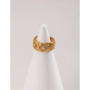 Gold and silver cuff rings with intricate detailing on a white surface, perfect for vintage jewelry collectors, jewelry designers, and jewelry websites. Ideal for jewelry storage, jewelry cases, and pairing with earrings rings or gem jewelry styles. A must-have for those seeking jewelry cleaning tips or diamond and jewelry care.