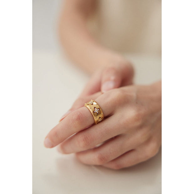 Gold and silver cuff rings with intricate detailing on a white surface, perfect for vintage jewelry collectors, jewelry designers, and jewelry websites. Ideal for jewelry storage, jewelry cases, and pairing with earrings rings or gem jewelry styles. A must-have for those seeking jewelry cleaning tips or diamond and jewelry care.