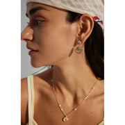 Gold and silver drop earrings with crystal accents, ideal for jewelry designers, jewelry websites, and jewelry storage. Perfect for vintage jewelry lovers, earrings rings combinations, and pairing with mature women hairstyles. A must-have for gem jewelry collections and diamond and jewelry enthusiasts.