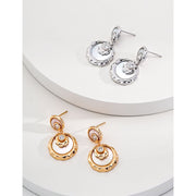 Gold and silver drop earrings with crystal accents, ideal for jewelry designers, jewelry websites, and jewelry storage. Perfect for vintage jewelry lovers, earrings rings combinations, and pairing with mature women hairstyles. A must-have for gem jewelry collections and diamond and jewelry enthusiasts.