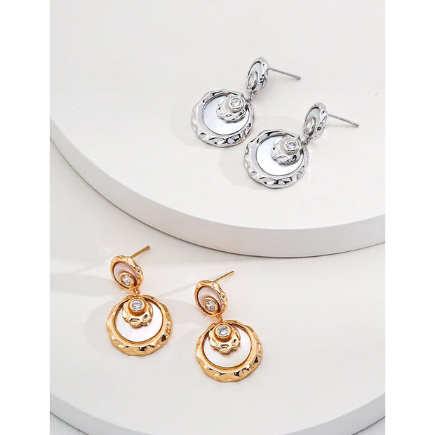 Gold and silver drop earrings with crystal accents, ideal for jewelry designers, jewelry websites, and jewelry storage. Perfect for vintage jewelry lovers, earrings rings combinations, and pairing with mature women hairstyles. A must-have for gem jewelry collections and diamond and jewelry enthusiasts.