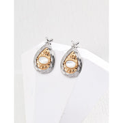 Gold and silver teardrop pearl earrings with intricate detailing, perfect for vintage jewelry lovers, jewelry designers, and jewelry websites. Ideal for jewelry storage, pairing with mature women hairstyles, and showcasing gem jewelry or diamond and jewelry collections.