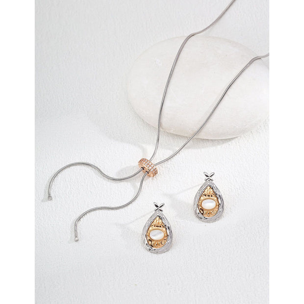 Gold and silver teardrop pearl earrings with intricate detailing, perfect for vintage jewelry lovers, jewelry designers, and jewelry websites. Ideal for jewelry storage, pairing with mature women hairstyles, and showcasing gem jewelry or diamond and jewelry collections.