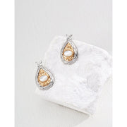 Gold and silver teardrop pearl earrings with intricate detailing, perfect for vintage jewelry lovers, jewelry designers, and jewelry websites. Ideal for jewelry storage, pairing with mature women hairstyles, and showcasing gem jewelry or diamond and jewelry collections.