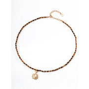 Boho sun pendant necklace with gold and beaded chain, perfect for jewelry websites, jewelry designers, jewelry storage, and vintage jewelry collections.