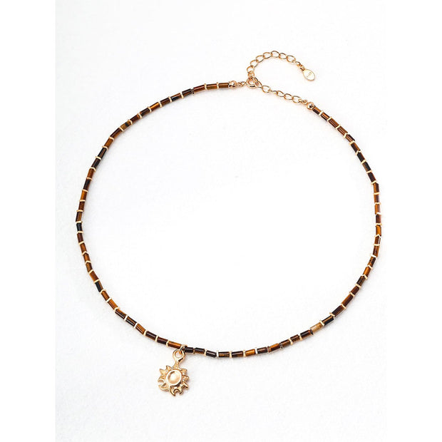 Boho sun pendant necklace with gold and beaded chain, perfect for jewelry websites, jewelry designers, jewelry storage, and vintage jewelry collections.