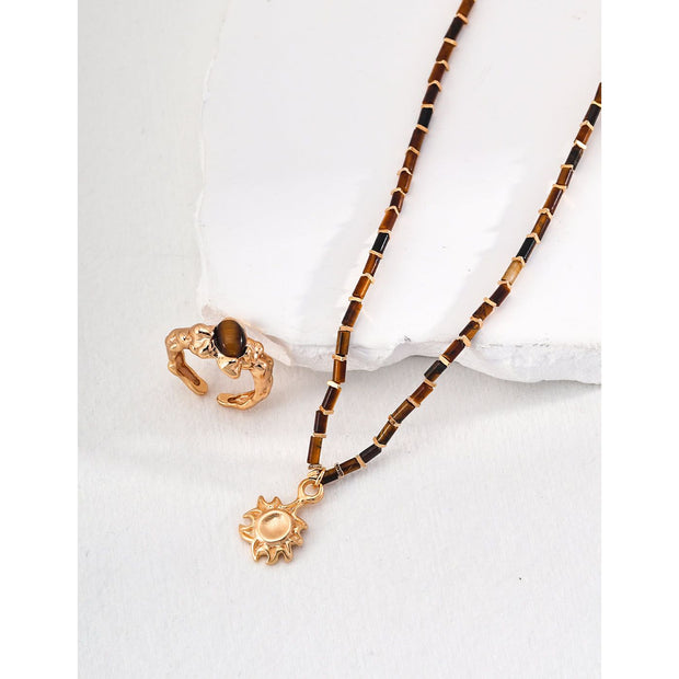 Boho sun pendant necklace with gold and beaded chain, perfect for jewelry websites, jewelry designers, jewelry storage, and vintage jewelry collections.