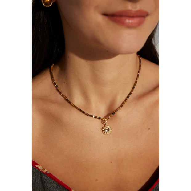 Boho sun pendant necklace with gold and beaded chain, perfect for jewelry websites, jewelry designers, jewelry storage, and vintage jewelry collections.