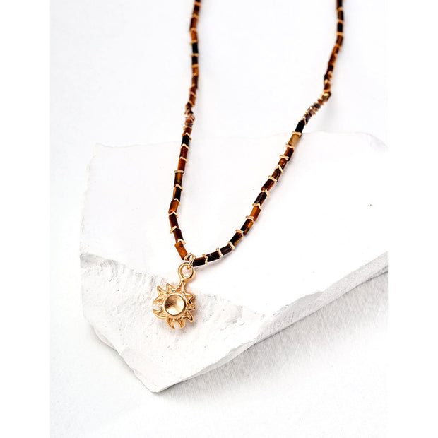 Boho sun pendant necklace with gold and beaded chain, perfect for jewelry websites, jewelry designers, jewelry storage, and vintage jewelry collections.