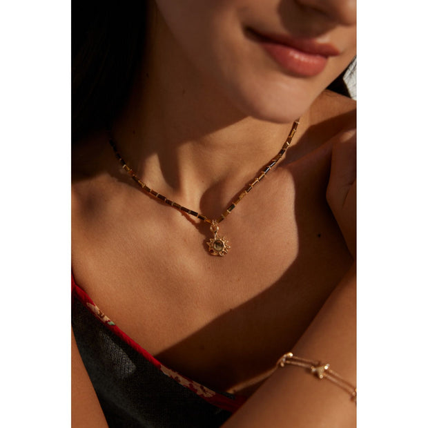Boho sun pendant necklace with gold and beaded chain, perfect for jewelry websites, jewelry designers, jewelry storage, and vintage jewelry collections.