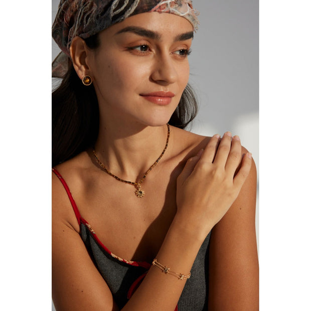 Boho sun pendant necklace with gold and beaded chain, perfect for jewelry websites, jewelry designers, jewelry storage, and vintage jewelry collections.