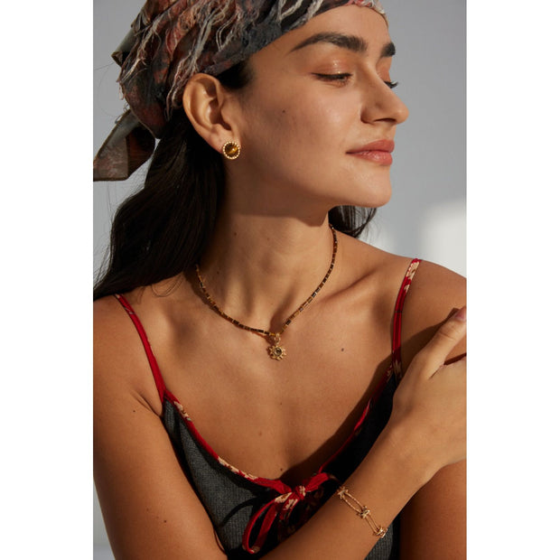 Boho sun pendant necklace with gold and beaded chain, perfect for jewelry websites, jewelry designers, jewelry storage, and vintage jewelry collections.