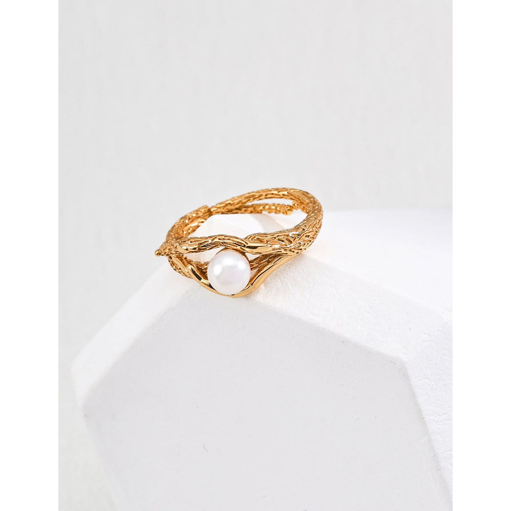 Gold textured ring with a pearl accent, perfect for jewelry storage, jewelry websites, vintage jewelry collections, and as a timeless accessory for all occasions.