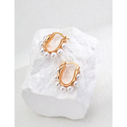 Gold and silver hoop earrings with pearl accents, ideal for jewelry storage, jewelry websites, vintage jewelry collections, and stylish everyday accessories.