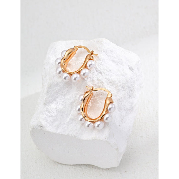 Gold and silver hoop earrings with pearl accents, ideal for jewelry storage, jewelry websites, vintage jewelry collections, and stylish everyday accessories.