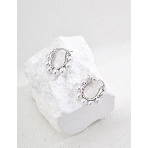 Gold and silver hoop earrings with pearl accents, ideal for jewelry storage, jewelry websites, vintage jewelry collections, and stylish everyday accessories.