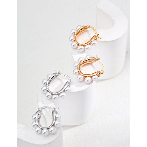 Gold and silver hoop earrings with pearl accents, ideal for jewelry storage, jewelry websites, vintage jewelry collections, and stylish everyday accessories.