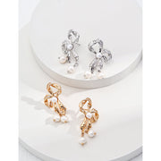 Gold and silver pearl bow earrings for jewelry storage and jewelry case enthusiasts. Perfect for vintage jewelry lovers, jewelry designers, and elegant styling.