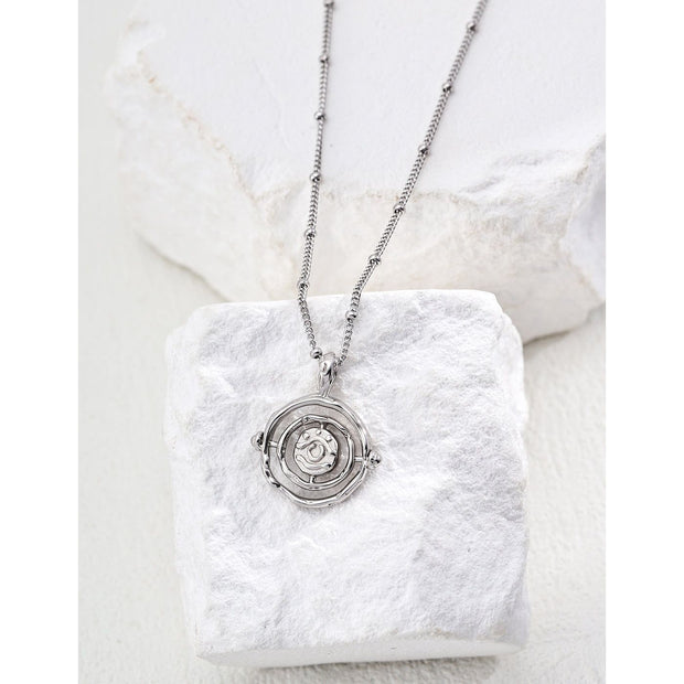 Gold and silver pendant necklaces with intricate rose design, perfect for jewelry storage in a jewelry case. Ideal for jewelry designers, jewelry websites, and vintage jewelry lovers. A timeless addition to jewelry brands, jewelry cleaning guides, or permanent jewelry collections.