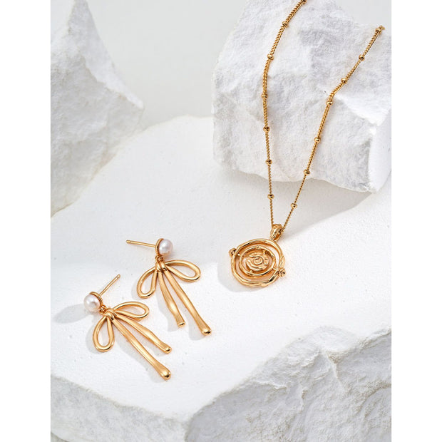 Gold and silver pendant necklaces with intricate rose design, perfect for jewelry storage in a jewelry case. Ideal for jewelry designers, jewelry websites, and vintage jewelry lovers. A timeless addition to jewelry brands, jewelry cleaning guides, or permanent jewelry collections.