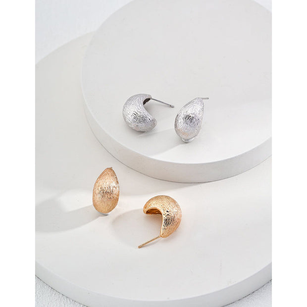 Gold and silver textured hoop earrings, perfect for jewelry storage, jewelry websites, vintage jewelry collections, and stylish accessories for all occasions.