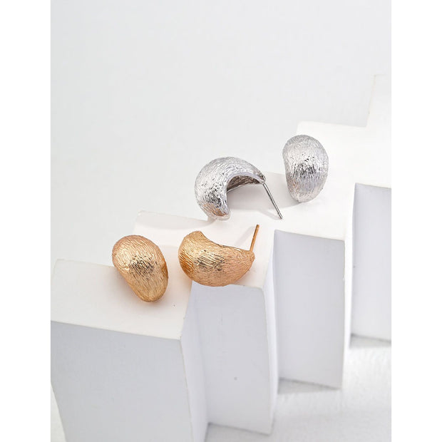 Gold and silver textured hoop earrings, perfect for jewelry storage, jewelry websites, vintage jewelry collections, and stylish accessories for all occasions.