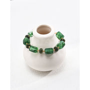 Green resin stone bracelet with gold accents, perfect for vintage jewelry lovers. Designed by expert jewelry designers, ideal for jewelry storage, jewelry websites, and jewelry cases. A great gift option for jewelry for mom or fans of gem jewelry and turquoise jewelry. Suitable for permanent jewelry collections or body jewelry.