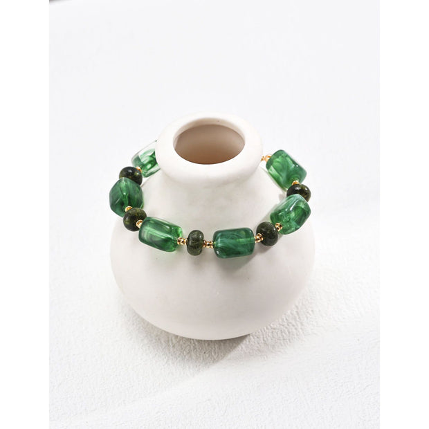 Green resin stone bracelet with gold accents, perfect for vintage jewelry lovers. Designed by expert jewelry designers, ideal for jewelry storage, jewelry websites, and jewelry cases. A great gift option for jewelry for mom or fans of gem jewelry and turquoise jewelry. Suitable for permanent jewelry collections or body jewelry.