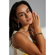 Green resin stone bracelet with gold accents, perfect for vintage jewelry lovers. Designed by expert jewelry designers, ideal for jewelry storage, jewelry websites, and jewelry cases. A great gift option for jewelry for mom or fans of gem jewelry and turquoise jewelry. Suitable for permanent jewelry collections or body jewelry.
