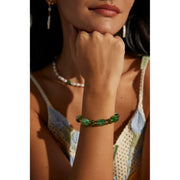 Green resin stone bracelet with gold accents, perfect for vintage jewelry lovers. Designed by expert jewelry designers, ideal for jewelry storage, jewelry websites, and jewelry cases. A great gift option for jewelry for mom or fans of gem jewelry and turquoise jewelry. Suitable for permanent jewelry collections or body jewelry.