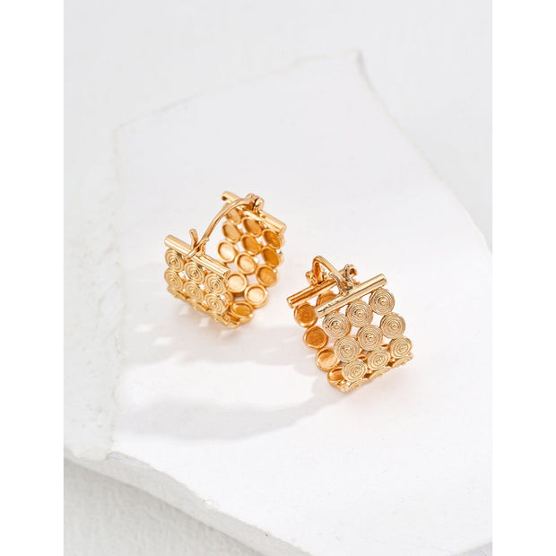 Gold filigree hoop earrings with intricate design, ideal for jewelry storage, jewelry websites, vintage jewelry collections, and sophisticated fashion looks.