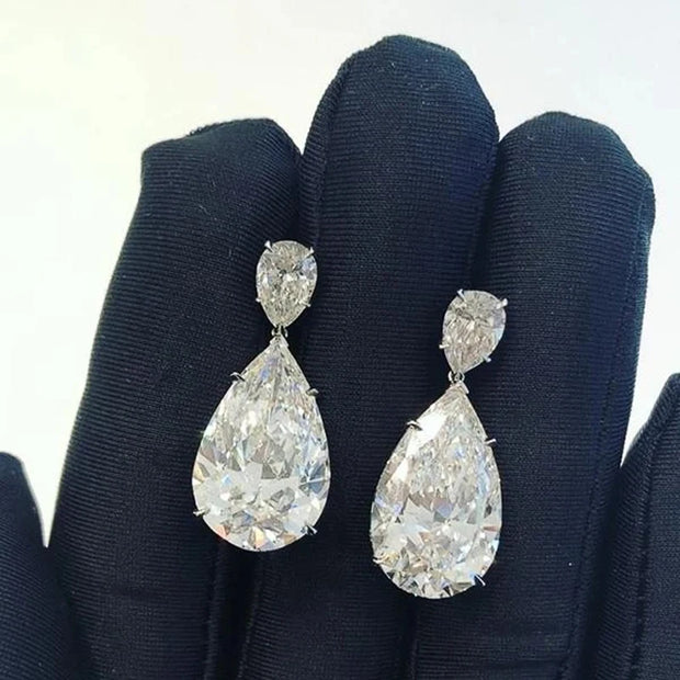 Elegant diamond drop earrings for jewelry designers, featuring teardrop design with sparkling diamonds, perfect for luxury jewelry websites, cases, and storage.