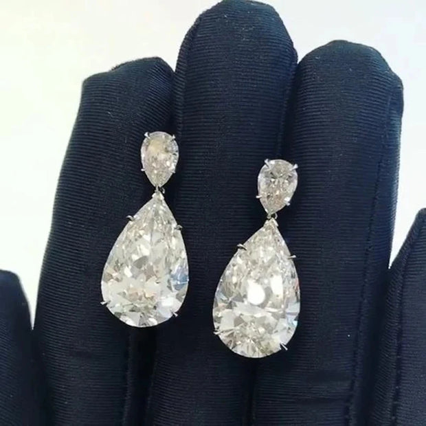 Elegant diamond drop earrings for jewelry designers, featuring teardrop design with sparkling diamonds, perfect for luxury jewelry websites, cases, and storage.