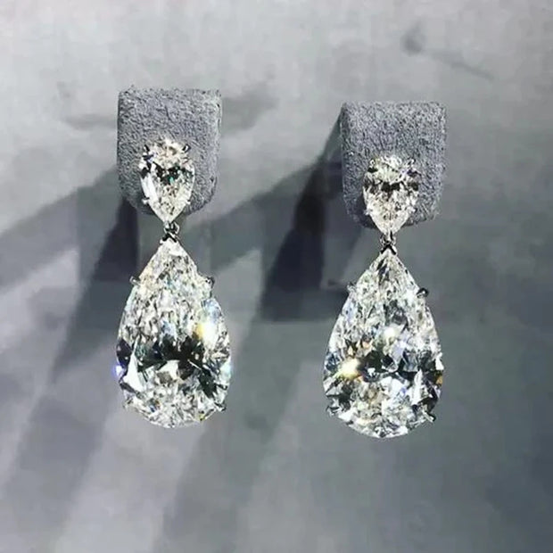 Elegant diamond drop earrings for jewelry designers, featuring teardrop design with sparkling diamonds, perfect for luxury jewelry websites, cases, and storage.